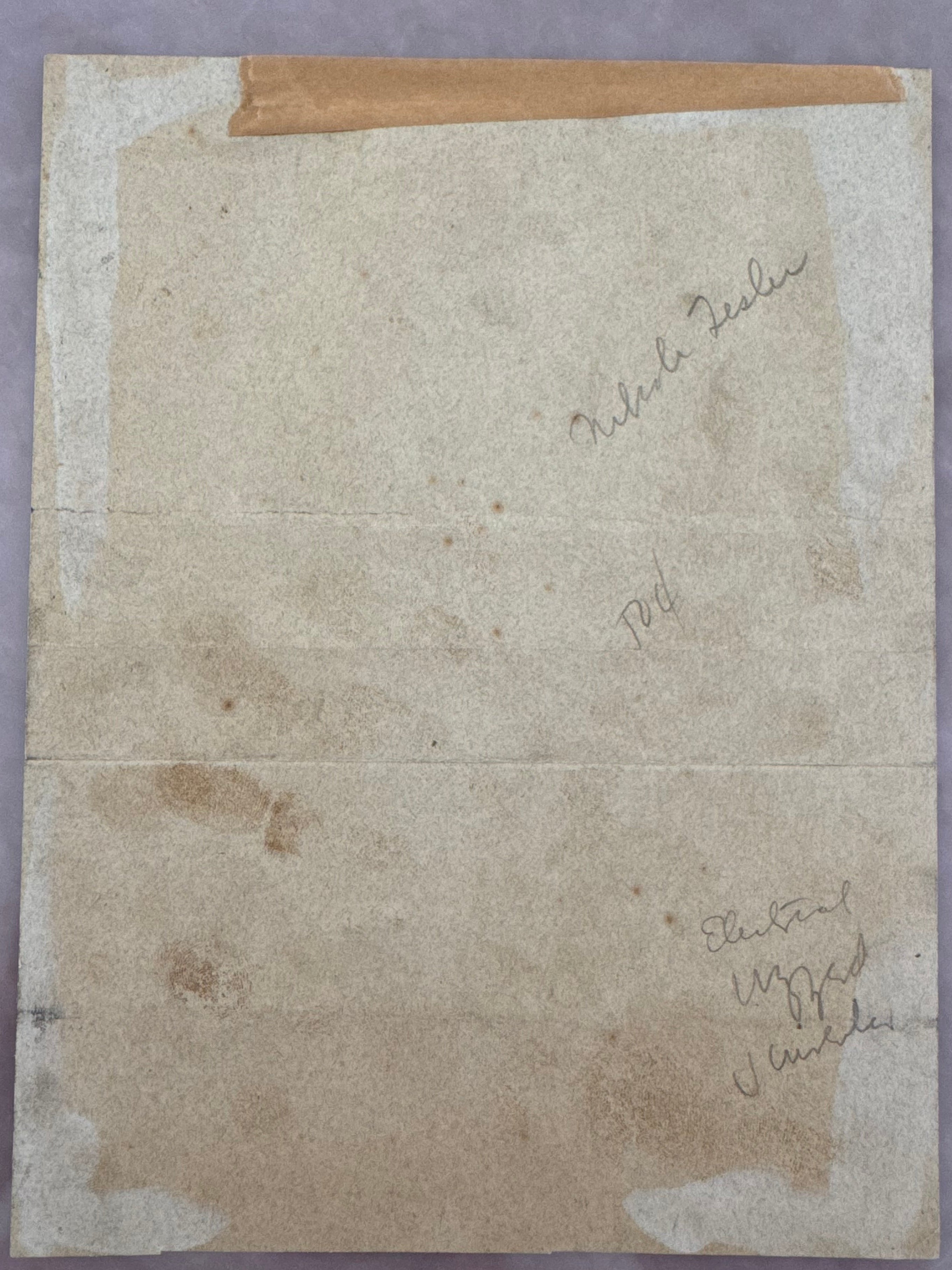 Back of Tesla signed doc. An aged, vintage beige paper document with handwritten markings.