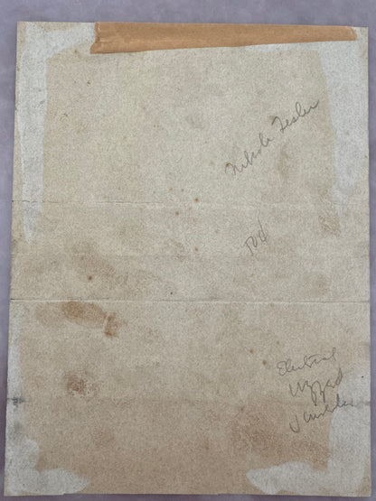 Back of Tesla signed doc. An aged, vintage beige paper document with handwritten markings.